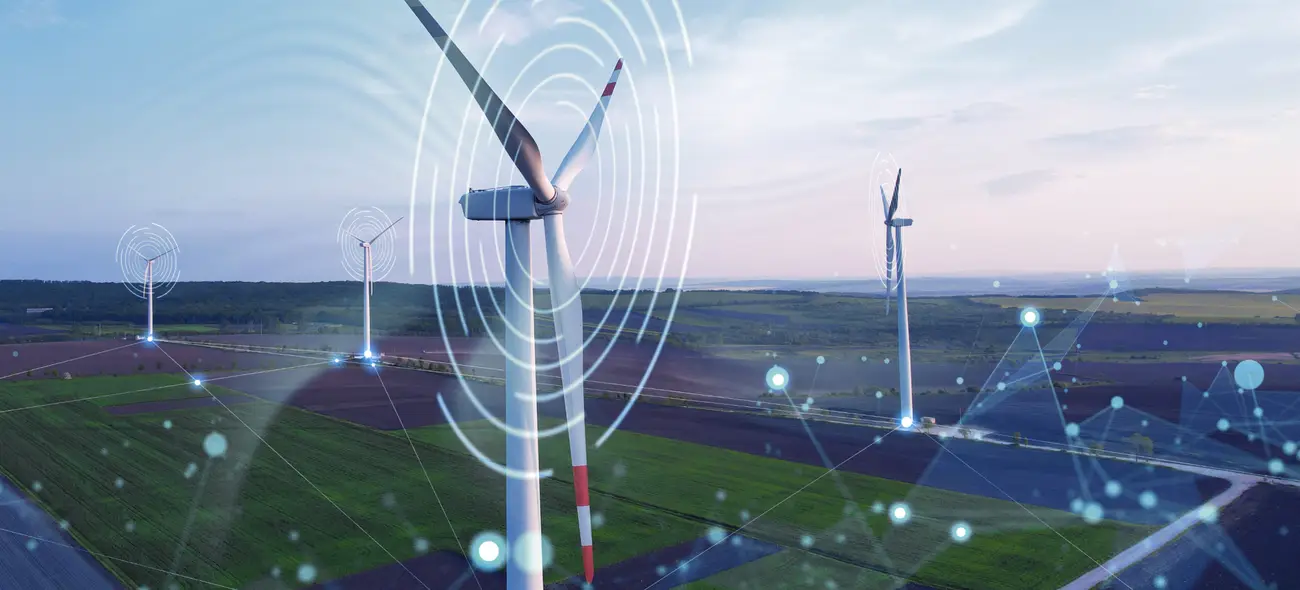 Wind turbines in a green landscape with digital graphics and data points.
