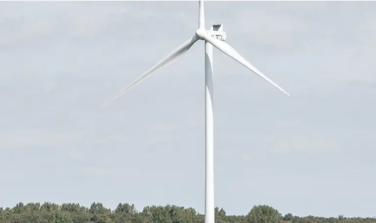 Einzelnes Windrad auf einem Feld in Hessen unter weitem Himmel.